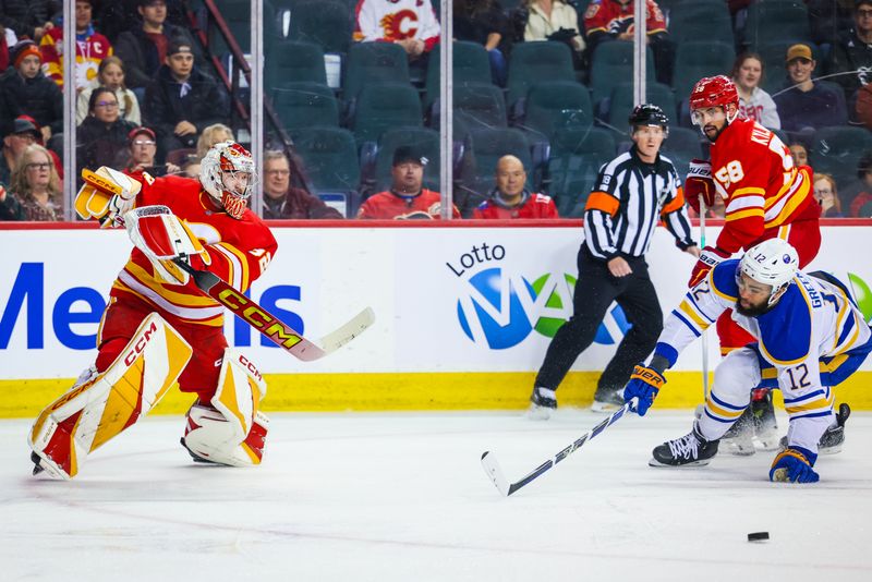 Mar 24, 2024; Calgary, Alberta, CAN; Calgary Flames goaltender Dustin Wolf (32) passes the puck against the Buffalo Sabres during the first period at Scotiabank Saddledome. Mandatory Credit: Sergei Belski-USA TODAY Sports