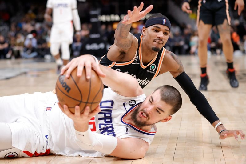 ATLANTA, GA - JANUARY 28: Ivica Zubac #40 of the LA Clippers and Dejounte Murray #5 of the Atlanta Hawks battle for the ball during the second half at State Farm Arena on January 28, 2023 in Atlanta, Georgia. NOTE TO USER: User expressly acknowledges and agrees that,  by downloading and or using this photograph,  User is consenting to the terms and conditions of the Getty Images License Agreement. (Photo by Alex Slitz/Getty Images)