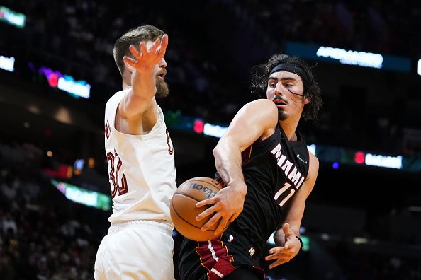 MIAMI, FLORIDA - DECEMBER 08: Jaime Jaquez Jr. #11 of the Miami Heat throws a pass against Dean Wade #32 of the Cleveland Cavaliers during the fourth quarter at Kaseya Center on December 08, 2023 in Miami, Florida. NOTE TO USER: User expressly acknowledges and agrees that, by downloading and or using this photograph, User is consenting to the terms and condtions of the Getty Images License Agreement.  (Photo by Rich Storry/Getty Images)