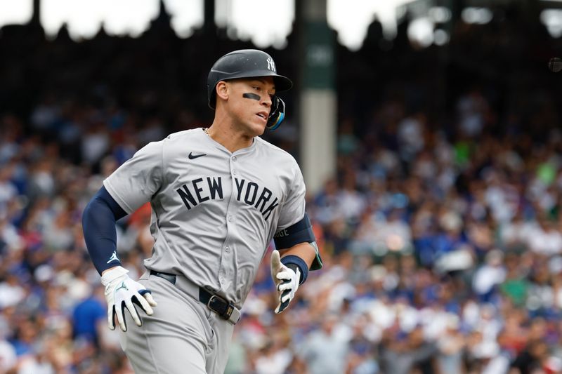 Sep 6, 2024; Chicago, Illinois, USA; New York Yankees outfielder Aaron Judge (99) runs after hitting an RBI-double against the Chicago Cubs during the third inning at Wrigley Field. Mandatory Credit: Kamil Krzaczynski-Imagn Images