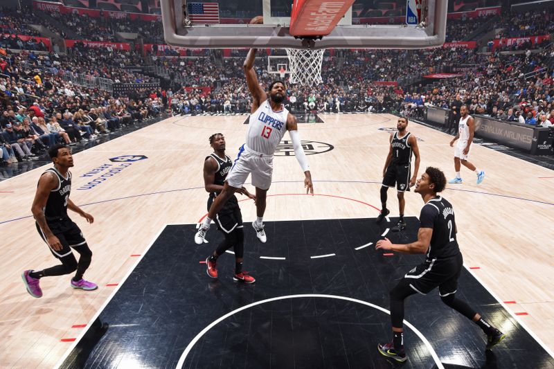 LOS ANGELES, CA - JANUARY 21: Paul George #13 of the LA Clippers dunks the ball during the game against the Brooklyn Nets on January 21, 2024 at Crypto.Com Arena in Los Angeles, California. NOTE TO USER: User expressly acknowledges and agrees that, by downloading and/or using this Photograph, user is consenting to the terms and conditions of the Getty Images License Agreement. Mandatory Copyright Notice: Copyright 2024 NBAE (Photo by Adam Pantozzi/NBAE via Getty Images)