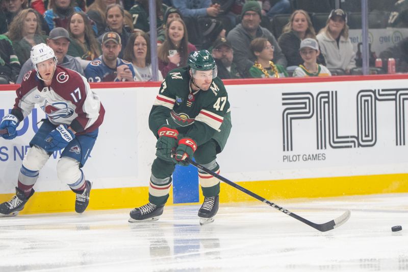 Mar 11, 2025; Saint Paul, Minnesota, USA; Minnesota Wild defenseman Declan Chisholm (47) intercepts a pass meant for Colorado Avalanche center Parker Kelly (17) in the first period at Xcel Energy Center. Mandatory Credit: Matt Blewett-Imagn Images