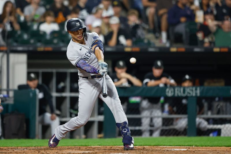 Aug 9, 2023; Chicago, Illinois, USA; New York Yankees designated hitter Giancarlo Stanton (27) hits a solo home run against the Chicago White Sox during the seventh inning at Guaranteed Rate Field. Mandatory Credit: Kamil Krzaczynski-USA TODAY Sports