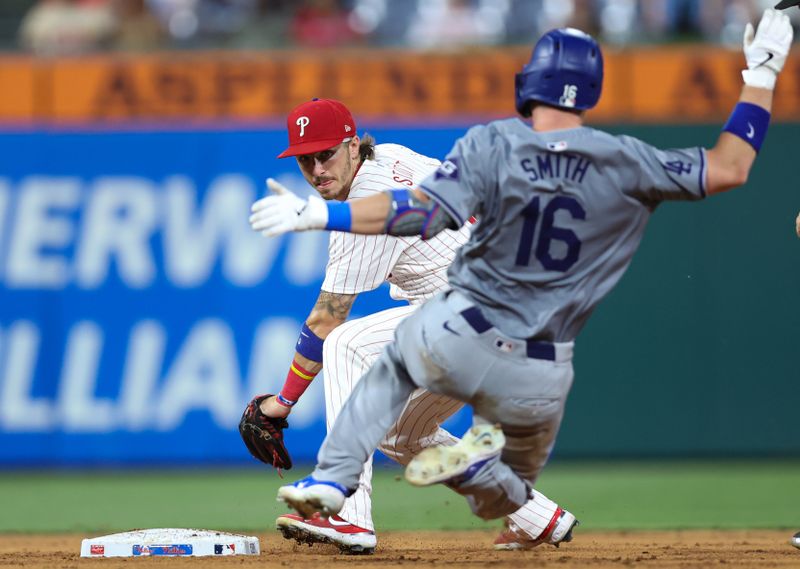 Jul 9, 2024; Philadelphia, Pennsylvania, USA; Philadelphia Phillies second base Bryson Stott (5) tags out Los Angeles Dodgers catcher Will Smith (16) as he tries to advance a single during the ninth inning at Citizens Bank Park. Mandatory Credit: Bill Streicher-USA TODAY Sports