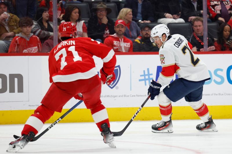 Mar 2, 2024; Detroit, Michigan, USA; Florida Panthers center Nick Cousins (21) skates with the puck defended by Detroit Red Wings center Dylan Larkin (71) in the third period at Little Caesars Arena. Mandatory Credit: Rick Osentoski-USA TODAY Sports