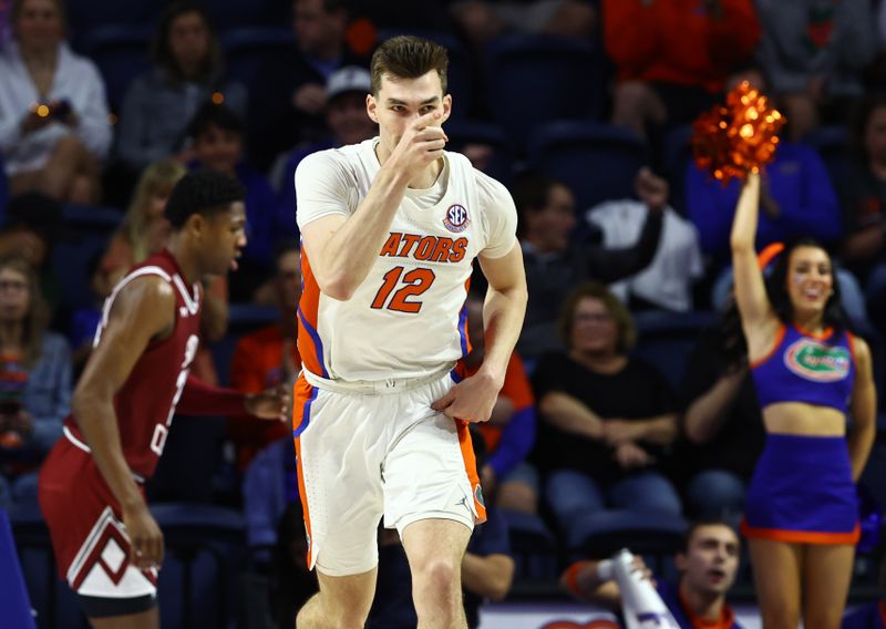 Jan 25, 2023; Gainesville, Florida, USA; Florida Gators forward Colin Castleton (12) points after scoring against the South Carolina Gamecocks during the first half at Exactech Arena at the Stephen C. O'Connell Center. Mandatory Credit: Kim Klement-USA TODAY Sports