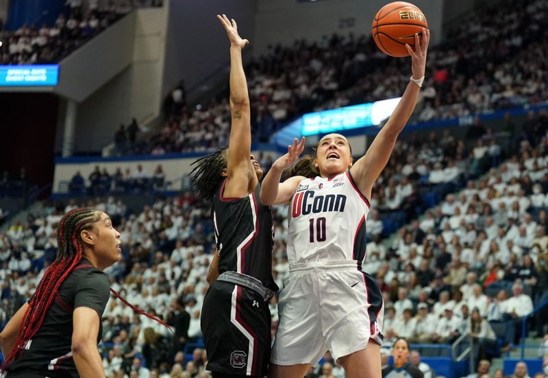 Feb 5, 2023; Hartford, Connecticut, USA; UConn Huskies guard Nika Muhl (10) drives to the basket against South Carolina Gamecocks guard Kierra Fletcher (41) in the first half at XL Center. Mandatory Credit: David Butler II-USA TODAY Sports