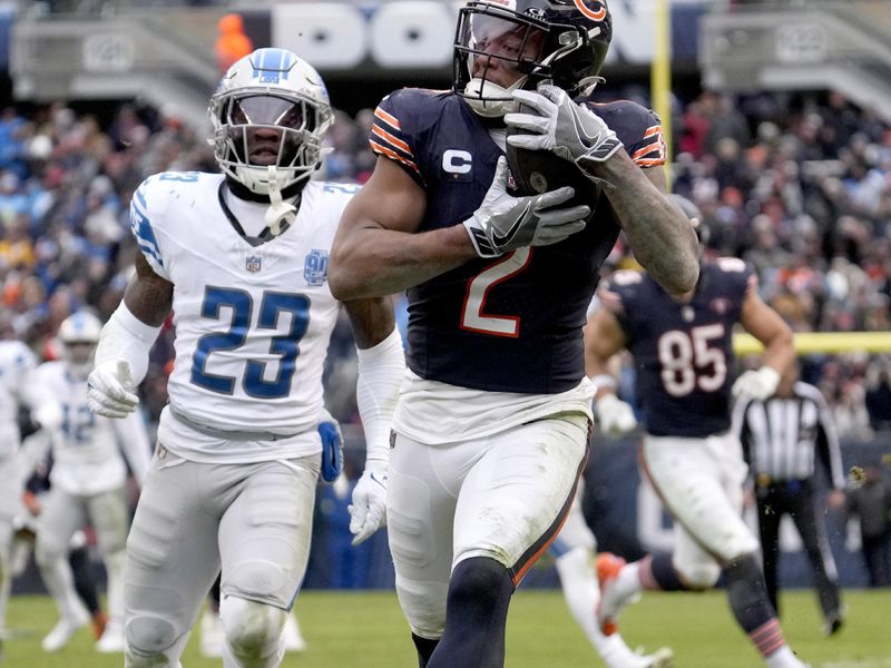 Chicago Bears wide receiver DJ Moore catches a touchdown pass from quarterback Justin Fields, as Detroit Lions cornerback Jerry Jacobs watches during the second half of an NFL football game against the Detroit Lions Sunday, Dec. 10, 2023, in Chicago. (AP Photo/Nam Y. Huh)