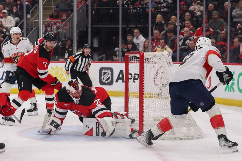 Mar 3, 2026; Newark, New Jersey, USA; New Jersey Devils goaltender Jacob Markstrom (25) makes a save on Florida Panthers center Sam Bennett (9) during the first period at Prudential Center. Mandatory Credit: Ed Mulholland-Imagn Images