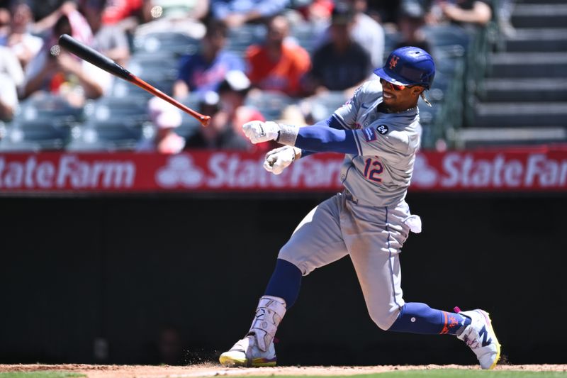 Aug 4, 2024; Anaheim, California, USA; New York Mets shortstop Francisco Lindor (12) loses grip of his bat against the Los Angeles Angels during the fifth inning at Angel Stadium. Mandatory Credit: Jonathan Hui-USA TODAY Sports