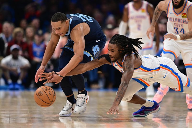 OKLAHOMA CITY, OKLAHOMA - DECEMBER 18: Cason Wallace #22 of the Oklahoma City Thunder (R) and Desmond Bane #22 of the Memphis Grizzlies dive for a loose ball during the second half at Paycom Center on December 18, 2023 in Oklahoma City, Oklahoma. NOTE TO USER: User expressly acknowledges and agrees that, by downloading and or using this Photograph, user is consenting to the terms and conditions of the Getty Images License Agreement. (Photo by Joshua Gateley/Getty Images)
