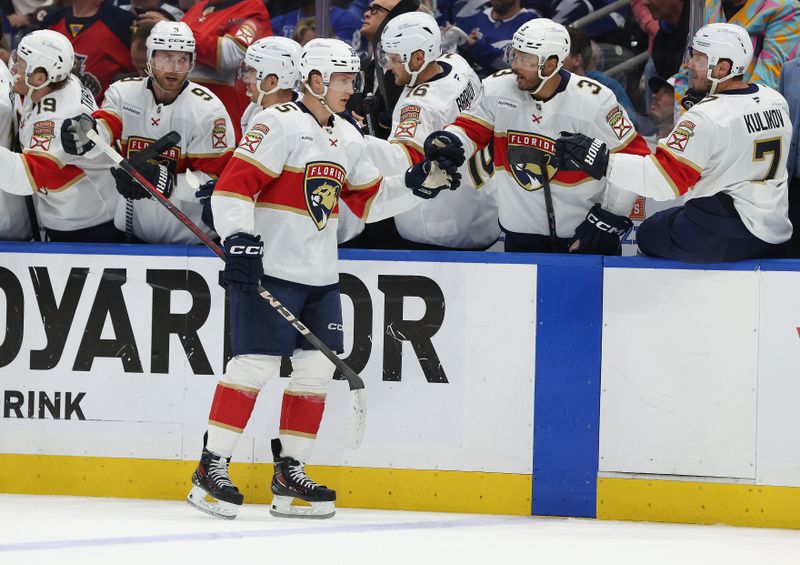 Apr 30, 2025; Tampa, Florida, USA; Florida Panthers center Anton Lundell (15) is congratulated  after he scored a goal against the Tampa Bay Lightning  during the first period of game five of the first round of the 2025 Stanley Cup Playoffs at Amalie Arena. Mandatory Credit: Kim Klement Neitzel-Imagn Images
