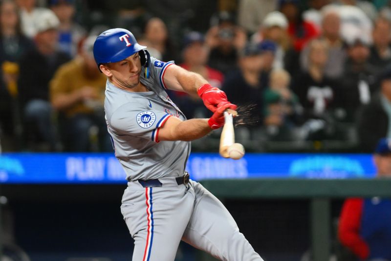 Sep 14, 2024; Seattle, Washington, USA; Texas Rangers left fielder Wyatt Langford (36) breaks his bat hitting a double against the Seattle Mariners during the first inning at T-Mobile Park. Mandatory Credit: Steven Bisig-Imagn Images