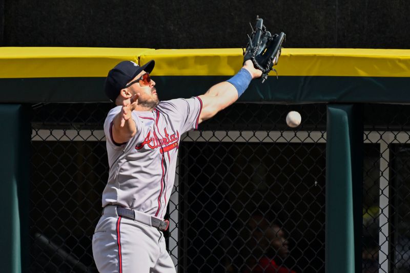 Jun 27, 2024; Chicago, Illinois, USA;  Atlanta Braves outfielder Adam Duvall (14) tries to make the play on the double hit by Chicago White Sox first base Andrew Vaughn (not pictured) during the sixth inning at Guaranteed Rate Field. Mandatory Credit: Matt Marton-USA TODAY Sports