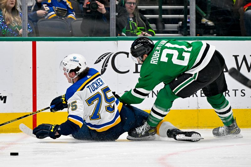 Apr 17, 2024; Dallas, Texas, USA; St. Louis Blues defenseman Tyler Tucker (75) and Dallas Stars left wing Jason Robertson (21) chase the puck in the Blues zone during the second period at the American Airlines Center. Mandatory Credit: Jerome Miron-USA TODAY Sports