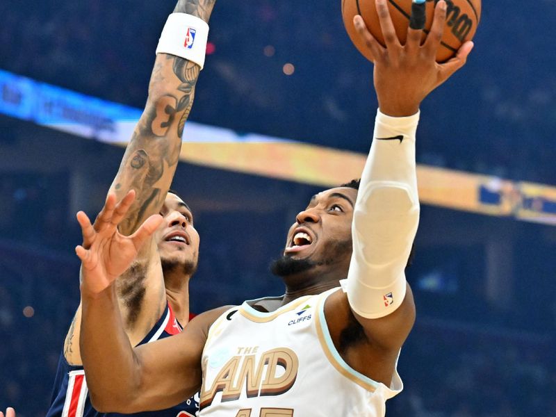 CLEVELAND, OHIO - MARCH 17: Donovan Mitchell #45 of the Cleveland Cavaliers shoots over Kyle Kuzma #33 of the Washington Wizards during the first half of the game at Rocket Mortgage Fieldhouse on March 17, 2023 in Cleveland, Ohio. NOTE TO USER: User expressly acknowledges and agrees that, by downloading and or using this photograph, User is consenting to the terms and conditions of the Getty Images License Agreement. (Photo by Jason Miller/Getty Images)