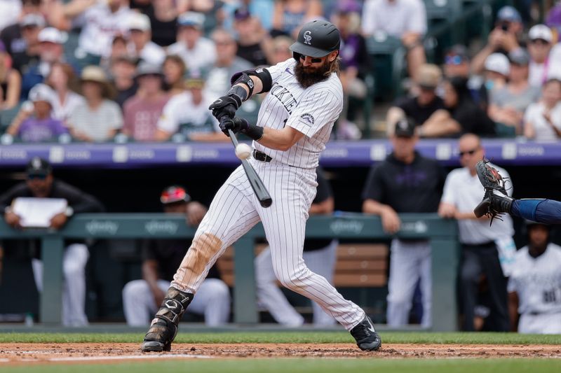 Aug 11, 2024; Denver, Colorado, USA; Colorado Rockies outfielder Charlie Blackmon (19) hits a single in the third inning against the Atlanta Braves at Coors Field. Mandatory Credit: Isaiah J. Downing-USA TODAY Sports