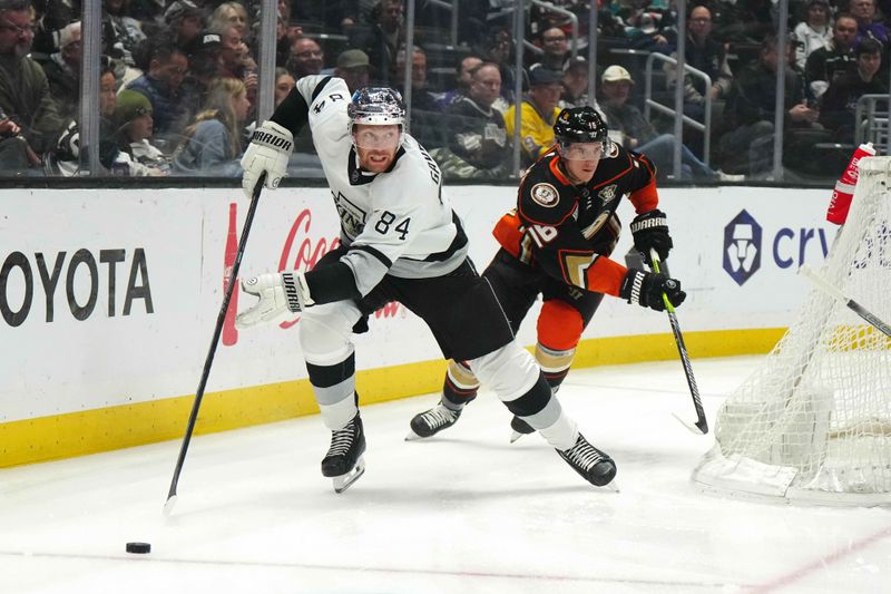 Apr 13, 2024; Los Angeles, California, USA; LA Kings defenseman Vladislav Gavrikov (84) skates with the puck against Anaheim Ducks center Ryan Strome (16) in the first period at Crypto.com Arena. Mandatory Credit: Kirby Lee-USA TODAY Sports