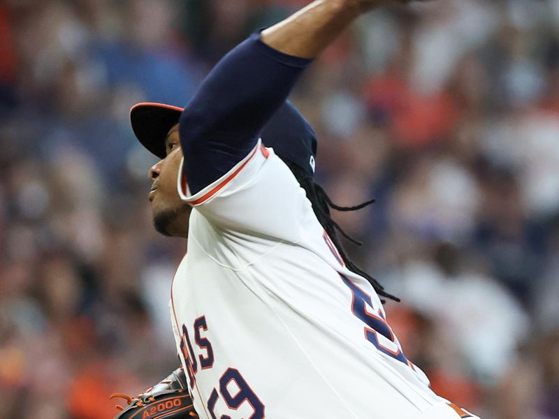 Jun 23, 2024; Houston, Texas, USA;  Houston Astros starting pitcher Framber Valdez (59) pitches against the Baltimore Orioles in the first inning at Minute Maid Park. Mandatory Credit: Thomas Shea-USA TODAY Sports