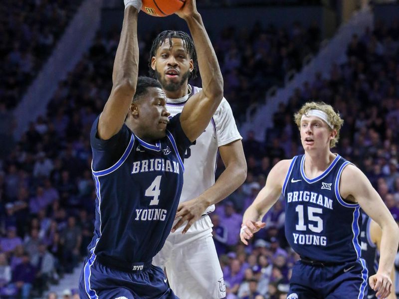 Feb 24, 2024; Manhattan, Kansas, USA; Brigham Young Cougars forward Atiki Ally Atiki (4) tries to keep the ball away from Kansas State Wildcats center Will McNair Jr. (13) during the second half at Bramlage Coliseum. Mandatory Credit: Scott Sewell-USA TODAY Sports