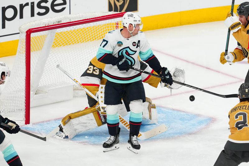 Apr 10, 2025; Las Vegas, Nevada, USA; Seattle Kraken center Jaden Schwartz (17) looks to deflect the puck in front of Vegas Golden Knights goaltender Adin Hill (33) during the third period at T-Mobile Arena. Mandatory Credit: Stephen R. Sylvanie-Imagn Images