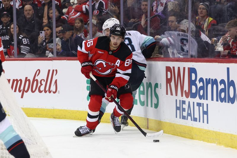 Dec 6, 2024; Newark, New Jersey, USA; New Jersey Devils center Jack Hughes (86) plays the puck against the Seattle Kraken during the second period at Prudential Center. Mandatory Credit: Ed Mulholland-Imagn Images