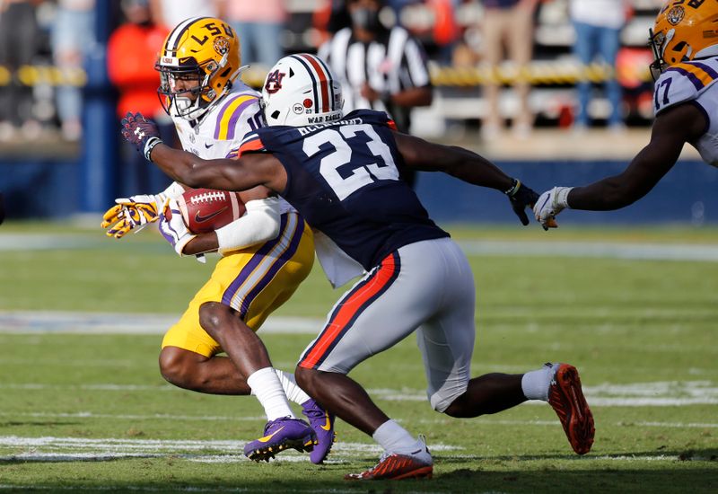 Oct 31, 2020; Auburn, Alabama, USA;  LSU Tigers receiver Jerry Jenkins (10) runs against Auburn Tigers defensive back Roger McCreary (23) during the second quarter at Jordan-Hare Stadium. Mandatory Credit: John Reed-USA TODAY Sports