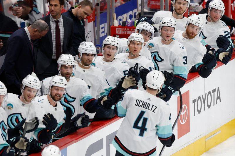 Jan 11, 2024; Washington, District of Columbia, USA; Seattle Kraken defenseman Justin Schultz (4) celebrates with teammates after scoring a goal against the Washington Capitals in the second period at Capital One Arena. Mandatory Credit: Geoff Burke-USA TODAY Sports