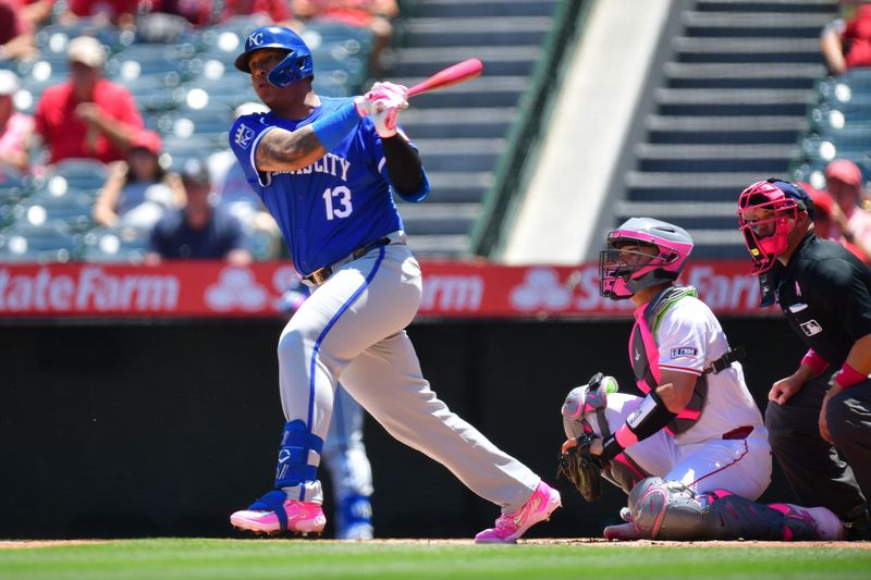 May 12, 2024; Anaheim, California, USA; Kansas City Royals first baseman Salvador Perez (13) hits a single against the Los Angeles Angels during the first inning at Angel Stadium. Mandatory Credit: Gary A. Vasquez-USA TODAY Sports