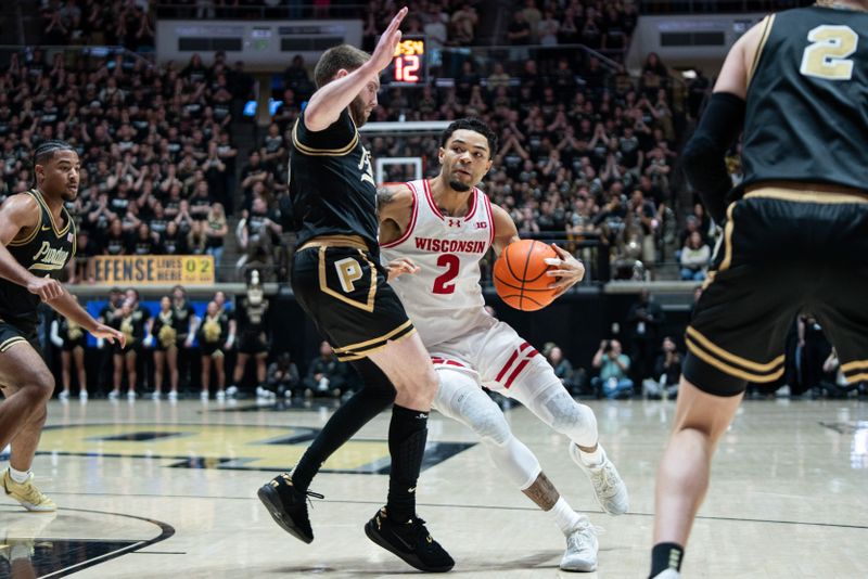 Mar 7, 2026; West Lafayette, Indiana, USA; Wisconsin Badgers guard Nick Boyd (2) drives to the basket as Purdue Boilermakers guard Braden Smith (3) defends during the first half at Mackey Arena. Mandatory Credit: Jacob Musselman-Imagn Images