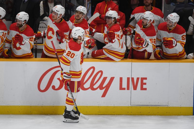 Jan 4, 2024; Nashville, Tennessee, USA; Calgary Flames center Blake Coleman (20) is congratulated by teammates after a goal during the first period against the Nashville Predators at Bridgestone Arena. Mandatory Credit: Christopher Hanewinckel-USA TODAY Sports