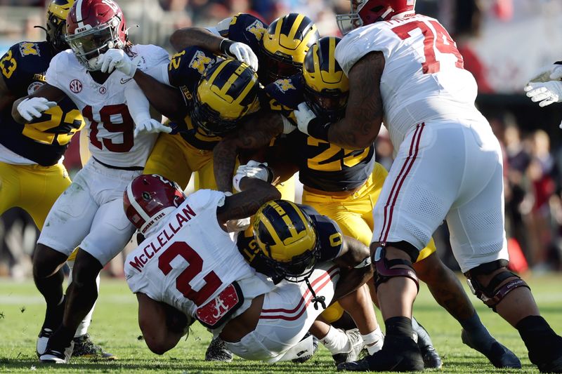 Jan 1, 2024; Pasadena, CA, USA; Michigan Wolverines defensive back Mike Sainristil (0) tackles Alabama Crimson Tide running back Jase McClellan (2) in the second quarter in the 2024 Rose Bowl college football playoff semifinal game at Rose Bowl. Mandatory Credit: Kiyoshi Mio-USA TODAY Sports