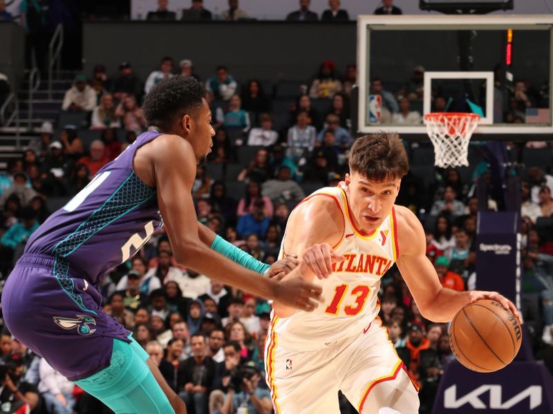 CHARLOTTE, NC - FEBRUARY 14: Bogdan Bogdanovic #13 of the Atlanta Hawks dribbles the ball during the game against the Charlotte Hornets on February 14, 2024 at Spectrum Center in Charlotte, North Carolina. NOTE TO USER: User expressly acknowledges and agrees that, by downloading and or using this photograph, User is consenting to the terms and conditions of the Getty Images License Agreement. Mandatory Copyright Notice: Copyright 2024 NBAE (Photo by Kent Smith/NBAE via Getty Images)