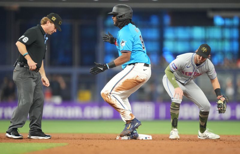 May 19, 2024; Miami, Florida, USA;  Miami Marlins designated hitter Josh Bell (9) hits a double in the first inning against the New York Mets at loanDepot Park. Mandatory Credit: Jim Rassol-USA TODAY Sports