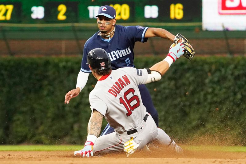 Jul 14, 2023; Chicago, Illinois, USA; Boston Red Sox left fielder Jarren Duran (16) is safe at second base with a double as Chicago Cubs second baseman Christopher Morel (5) makes a late tag during the third inning at Wrigley Field. Mandatory Credit: David Banks-USA TODAY Sports