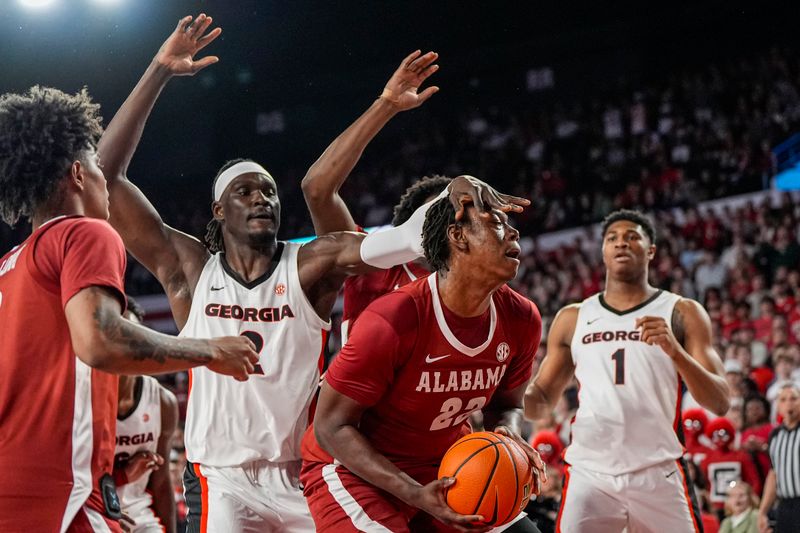 Mar 3, 2026; Athens, Georgia, USA; Alabama Crimson forward Aiden Sherrell (22) grabs a rebound behind Georgia Bulldogs center Somto Cyril (2) during the first half at Stegeman Coliseum. Mandatory Credit: Dale Zanine-Imagn Images