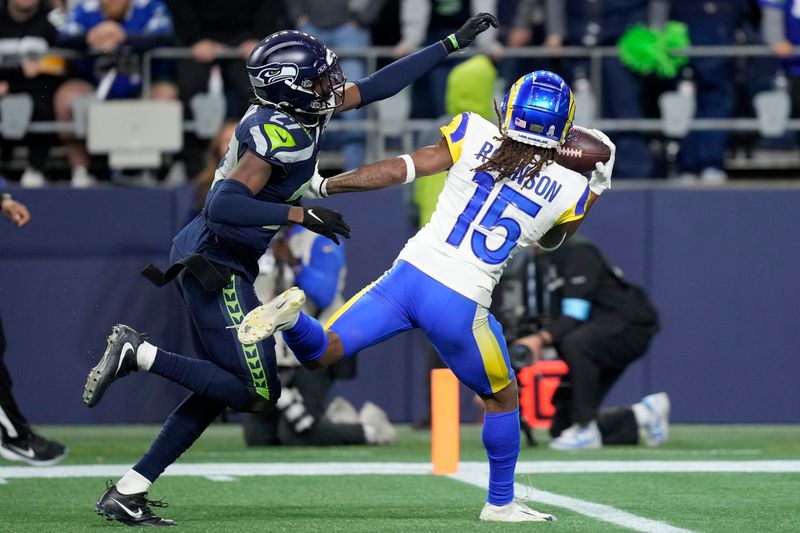 Los Angeles Rams wide receiver Demarcus Robinson (15) catches a touchdown pass against Seattle Seahawks cornerback Riq Woolen during overtime of an NFL football game in Seattle, Sunday, Nov. 3, 2024. (AP Photo/Stephen Brashear)