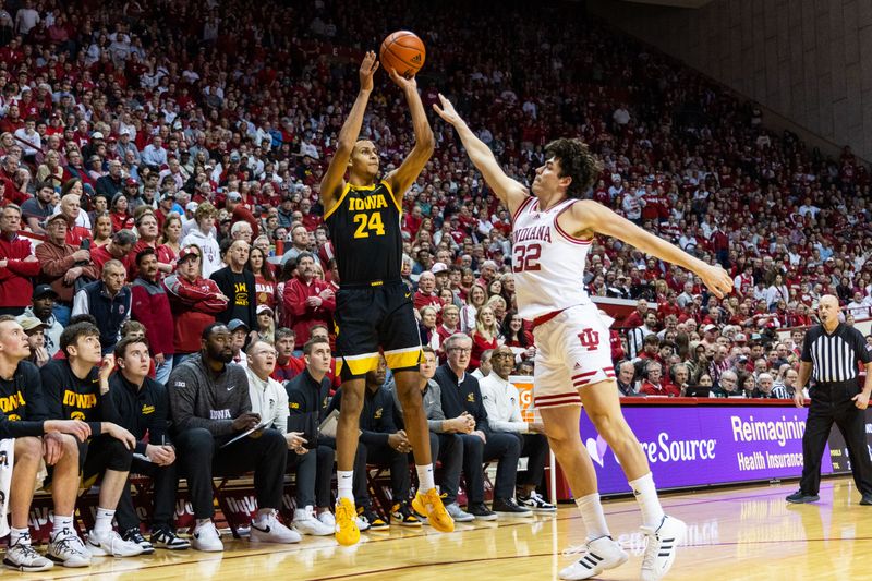 Feb 28, 2023; Bloomington, Indiana, USA; Iowa Hawkeyes forward Kris Murray (24) shoots the ball while Indiana Hoosiers guard Trey Galloway (32) defends in the second half at Simon Skjodt Assembly Hall. Mandatory Credit: Trevor Ruszkowski-USA TODAY Sports