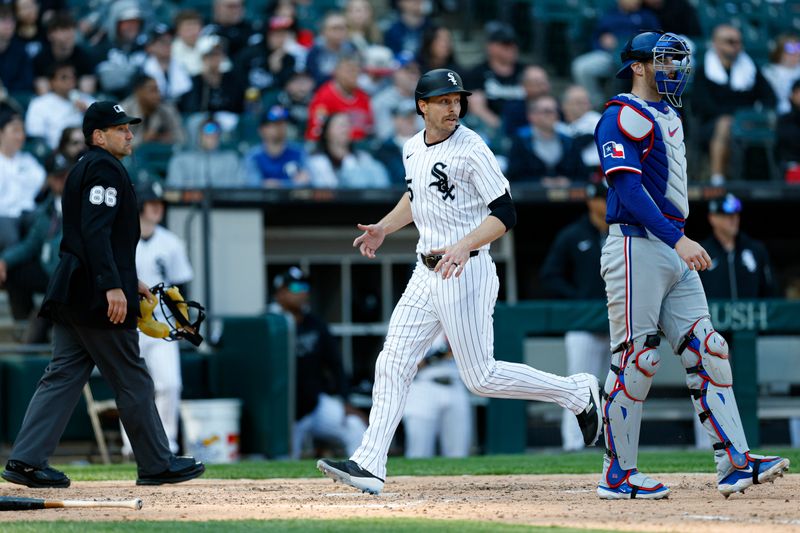 May 24, 2025; Chicago, Illinois, USA; Chicago White Sox outfielder Austin Slater (15) scores against the Texas Rangers during the sixth inning at Rate Field. Mandatory Credit: Kamil Krzaczynski-Imagn Images