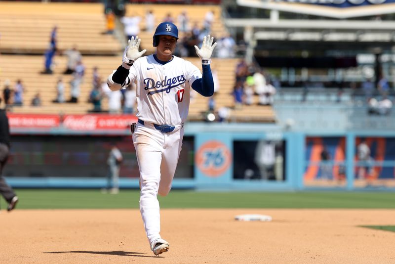 Sep 8, 2024; Los Angeles, California, USA;  Los Angeles Dodgers designated hitter Shohei Ohtani (17) reacts as he is running around bases after hitting a home run during the fifth inning against the Cleveland Guardians at Dodger Stadium. Mandatory Credit: Kiyoshi Mio-Imagn Images