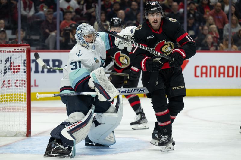 Nov 2, 2024; Ottawa, Ontario, CAN; Seattle Kraken goaltender Philipp Grubauer (31) and Ottawa Senators right wing Zack MacEwen (17) follow the puck in the first period at the Canadian Tire Centre. Mandatory Credit: Marc DesRosiers-Imagn Images