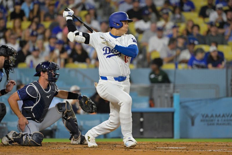 Aug 23, 2024; Los Angeles, California, USA;  Los Angeles Dodgers designated hitter Shohei Ohtani (17) singles in the fourth inning against the Tampa Bay Rays at Dodger Stadium. Mandatory Credit: Jayne Kamin-Oncea-USA TODAY Sports