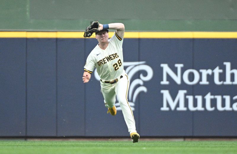 Jun 20, 2023; Milwaukee, Wisconsin, USA; Milwaukee Brewers center fielder Joey Wiemer (28) catches a fly ball on the run agains the Arizona Diamondbacks in the first inning at American Family Field. Mandatory Credit: Michael McLoone-USA TODAY Sports