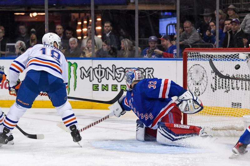 Dec 22, 2023; New York, New York, USA;  Edmonton Oilers left wing Zach Hyman (18) scores a goal on New York Rangers goaltender Jonathan Quick (32) during the third period at Madison Square Garden. Mandatory Credit: Dennis Schneidler-USA TODAY Sports