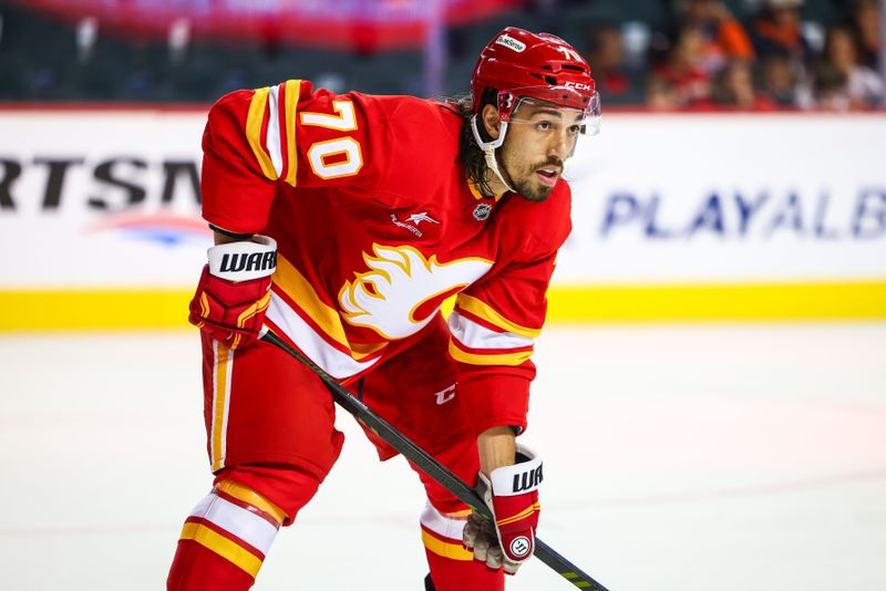 Sep 23, 2024; Calgary, Alberta, CAN; Calgary Flames left wing Ryan Lomberg (70) during the face off against the Edmonton Oilers during the first period at Scotiabank Saddledome. Mandatory Credit: Sergei Belski-Imagn Images