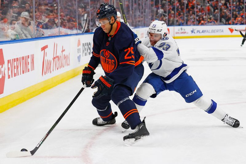 Dec 14, 2023; Edmonton, Alberta, CAN; Edmonton Oilers defensemen Darnell Nurse (25) protects the puck from Tampa Bay Lightning forward Connor Sheary (73) during the second period at Rogers Place. Mandatory Credit: Perry Nelson-USA TODAY Sports