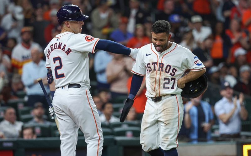 Apr 3, 2024; Houston, Texas, USA; Houston Astros second baseman Jose Altuve (27) reacts with third baseman Alex Bregman (2) after scoring a run during the fourth inning against the Toronto Blue Jays at Minute Maid Park. Mandatory Credit: Troy Taormina-USA TODAY Sports