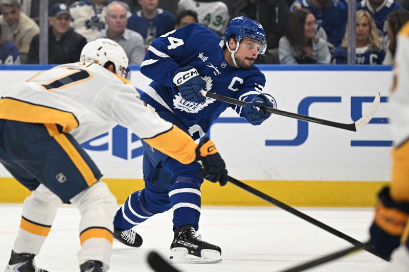 Oct 14, 2025; Toronto, Ontario, CAN;   Toronto Maple Leafs forward Auston Matthews (34) shoots the puck against the Nashville Predators in the first period at Scotiabank Arena. Mandatory Credit: Dan Hamilton-Imagn Images