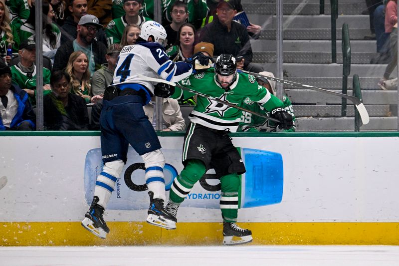 Dec 1, 2024; Dallas, Texas, USA; Dallas Stars center Colin Blackwell (15) checks Winnipeg Jets defenseman Haydn Fleury (24) during the third period at the American Airlines Center. Mandatory Credit: Jerome Miron-Imagn Images