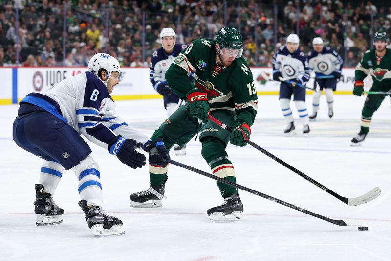 Sep 30, 2025; Saint Paul, Minnesota, USA; Minnesota Wild center Yakov Trenin (13) and Winnipeg Jets defenseman Colin Miller (6) compete for the puck during the second period at Grand Casino Arena. Mandatory Credit: Matt Krohn-Imagn Images